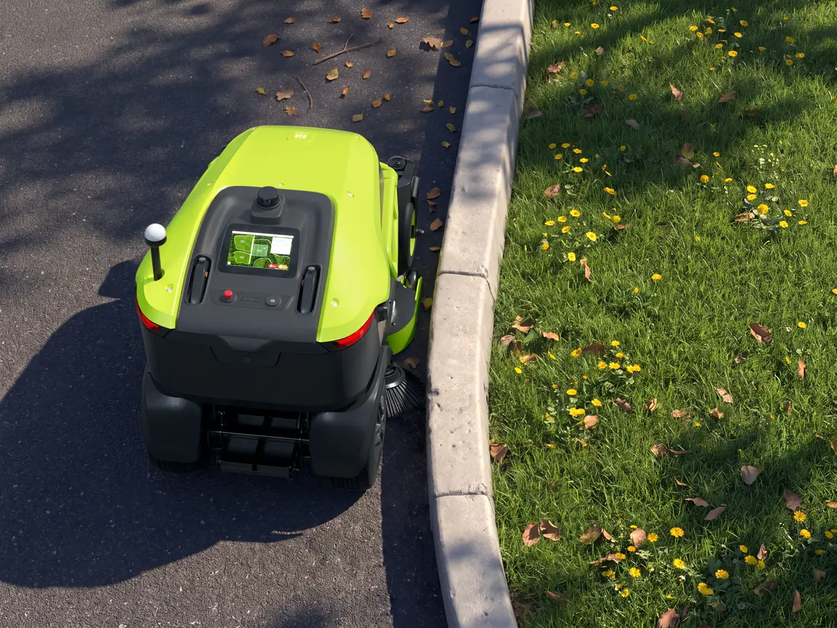 Le PUDU GT3 balaie le long d'une bordure de trottoir