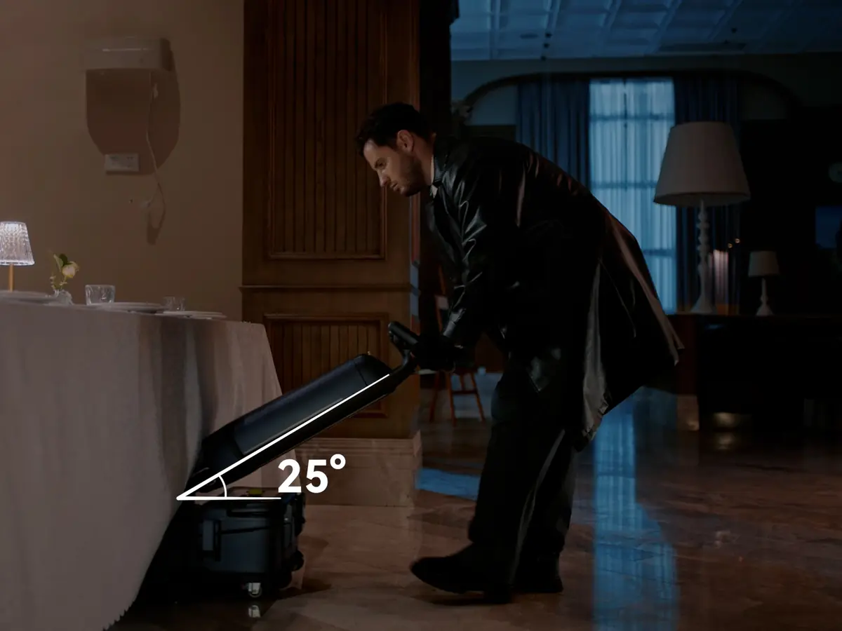 The PUDU SH1 handle tilted to reach under a table